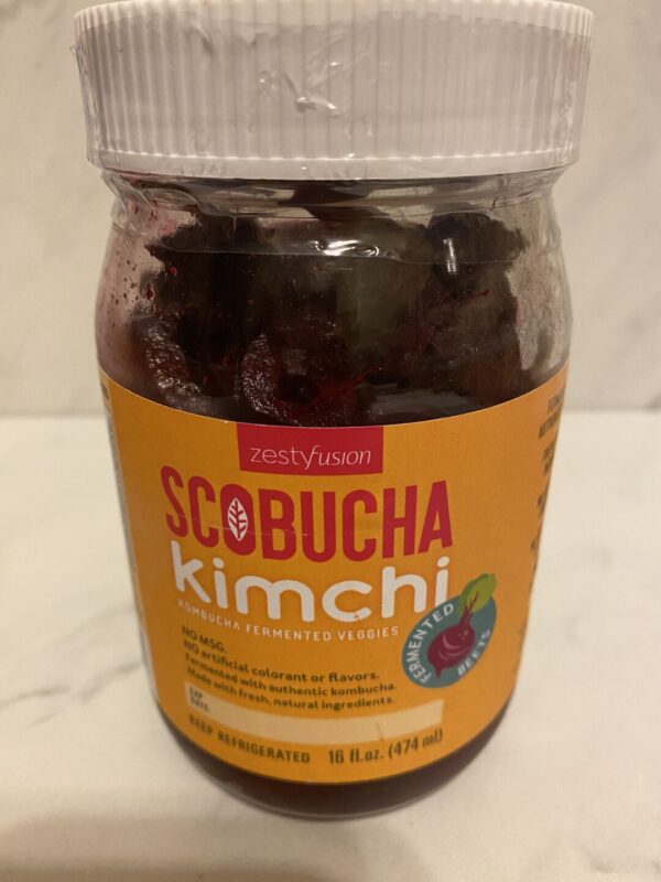 A jar of scobucha kimchi sitting on top of a table.