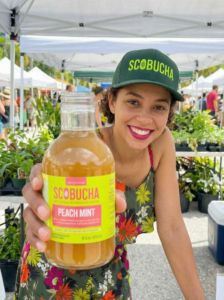Women in the farmers market drinking Scobucha